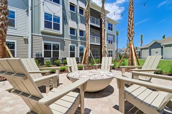 Fire pit with adirondack chairs and palm trees